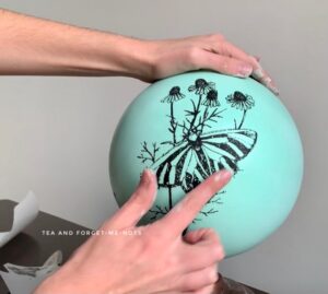 Burnishing the transfer using my finger - how to upcycle a children’s globe