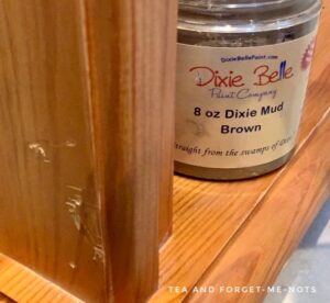 Using Dixie mud to fill dents on the bookshelf 