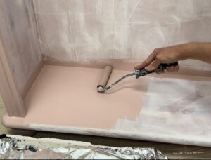 Applying the paint with a roller