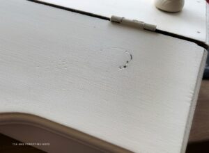 A painted over wood knot