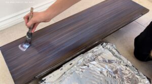 Adding sealer to the shelves