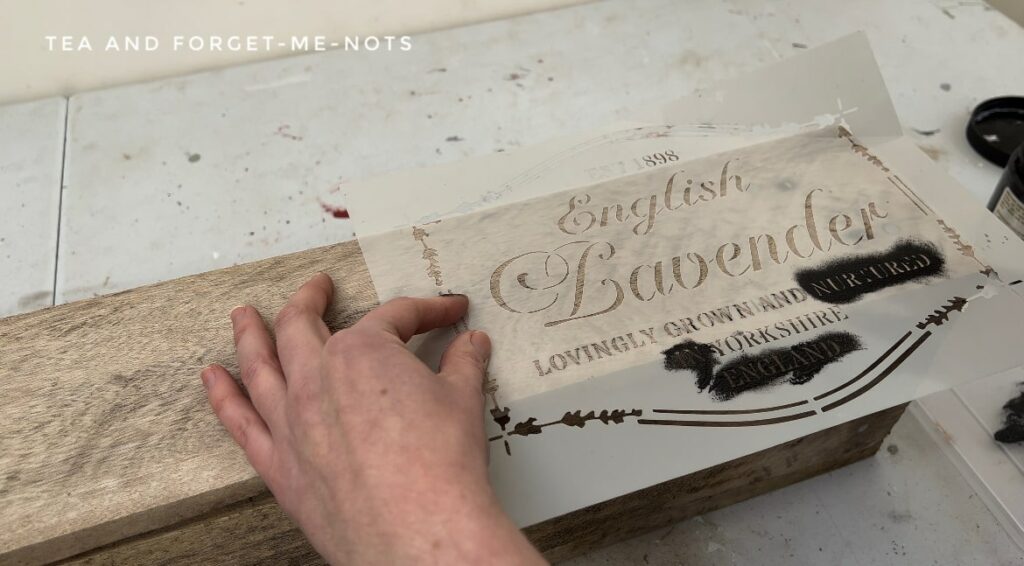 Painting the stencil on the pallet wood shelf