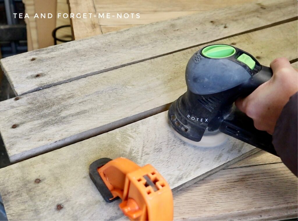 Sanding the pallet wood boards