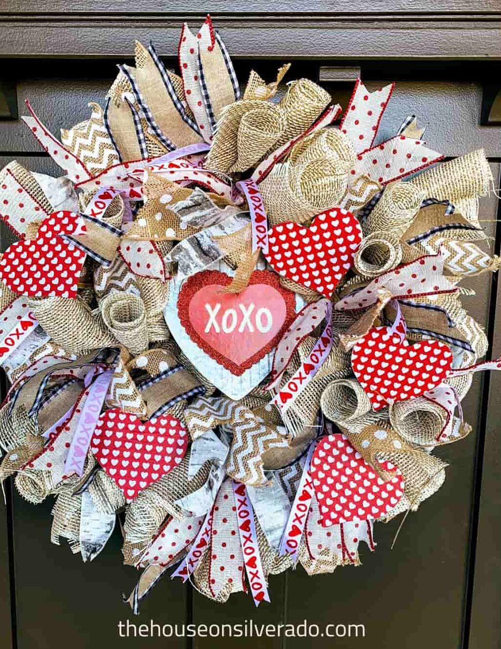 image shows burlap wreath with red hearts.