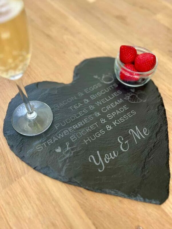 valentines gift engraved slate with drink and strawberries on top.