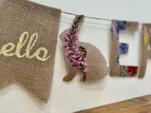 image shows a close up of burlap Easter garland.