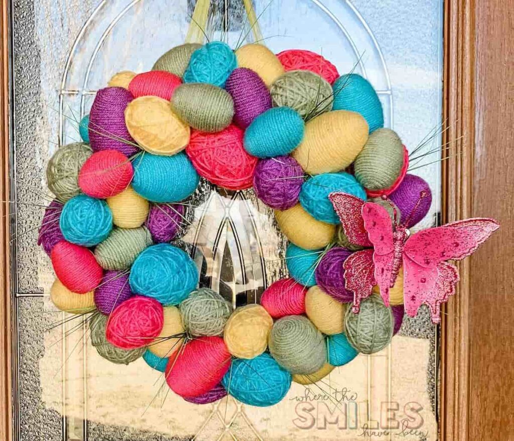 image shows easter egg wreath on door.
