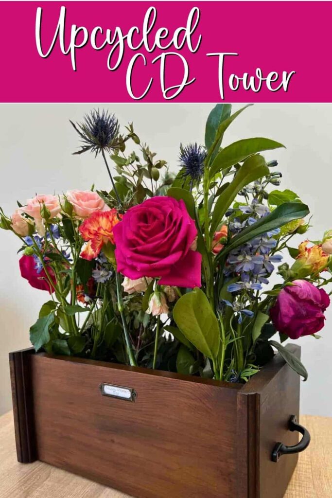 image shows cd tower upcycled into flower box.